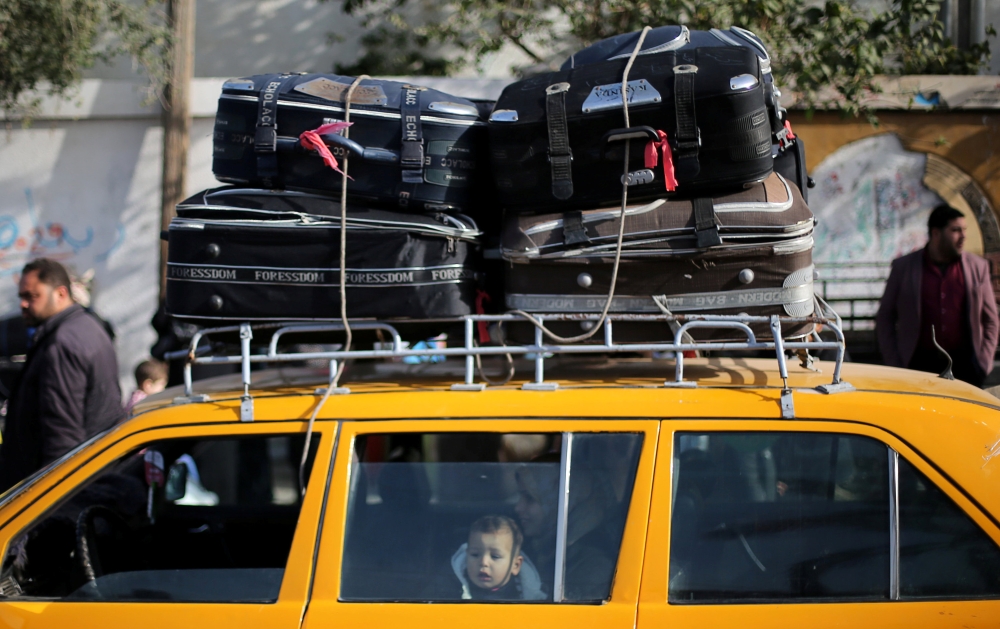 A Palestinian boy waits to cross into Egypt through the Rafah border crossing after it was opened by Egyptian authorities for humanitarian cases, in the southern Gaza Strip February 09, 2018. Reuters/Ibraheem Abu Mustafa