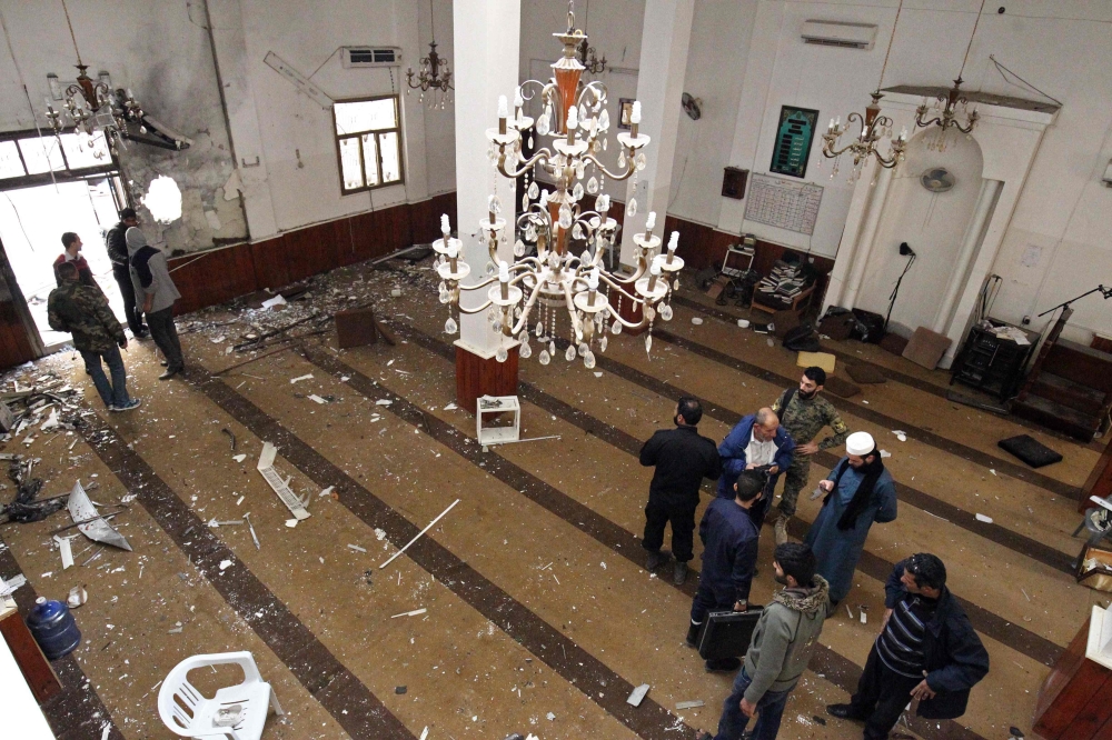 Libyans inspect the interior of a mosque in Benghazi on February 9, 2018, after it was hit with a twin bomb attack. AFP / Abdullah Doma 
 

