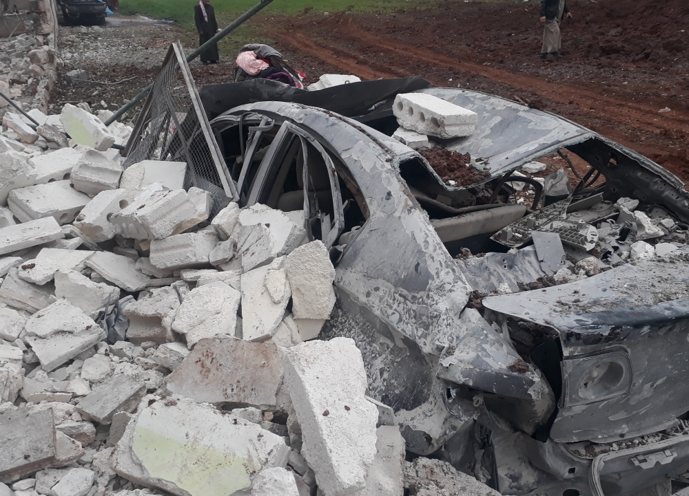 A wrecked vehicle is seen after an airstrike Hazzano town of Idlib, Syria on February 17, 2018. Ahmet Hatib - Anadolu
