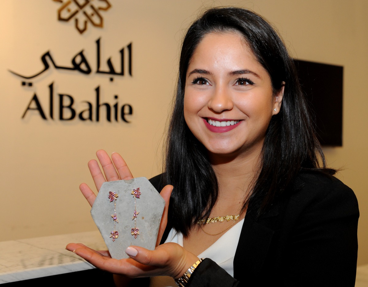 Qatari jewellery designer Leila Abu Issa shows the earrings she designed which will be auctioned at the 15th Doha Jewellery and Watches Exhibition. Pic: Salim Matramkot/The Peninsula