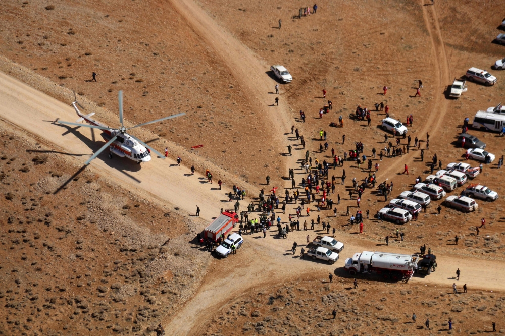 Iranian rescue teams gathering in the area of a search operation for the wreckage of a plane that crashed near a mountain peak two days earlier in Iran's Zagros mountain range.  AFP /Mohammed KHADEMOSHEIKH
