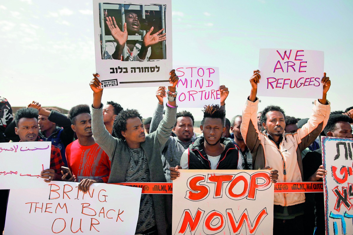 African migrants protest outside the Saharonim Prison, an Israeli detention facility for African asylum seekers near Holot, where at least nine others have been incarcerated as part of Israel's new policy of prison or deportation for migrants, in Israel's