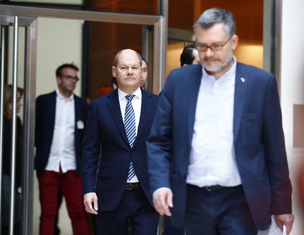 Dietmar Nietan (R) and Olaf Scholz of Social Democratic Party (SPD) attend a news conference to announce the results of the voting for a possible coalition between the Social Democratic Party (SPD) and the Christian Democratic Union (CDU) in Berlin, Germa