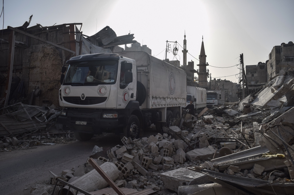 United Nations' aid convoy enters the Douma town of Eastern Ghouta after Assad Regime stopped the assaults in Damascus, Syria on March 05, 2018. (Mouneb Taim - Anadolu Agency)