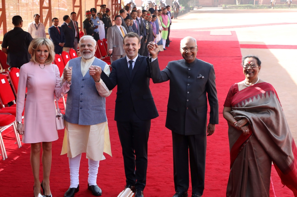France's President Emmanuel Macron (C) poses with India's President Ram Nath Kovind (2nd R), Macron's wife Brigitte (L), Kovind's wife Savita and India's Prime Minister Narendra Modi (2nd L) during a ceremonial reception in New Delhi on March 10, 2018. AF