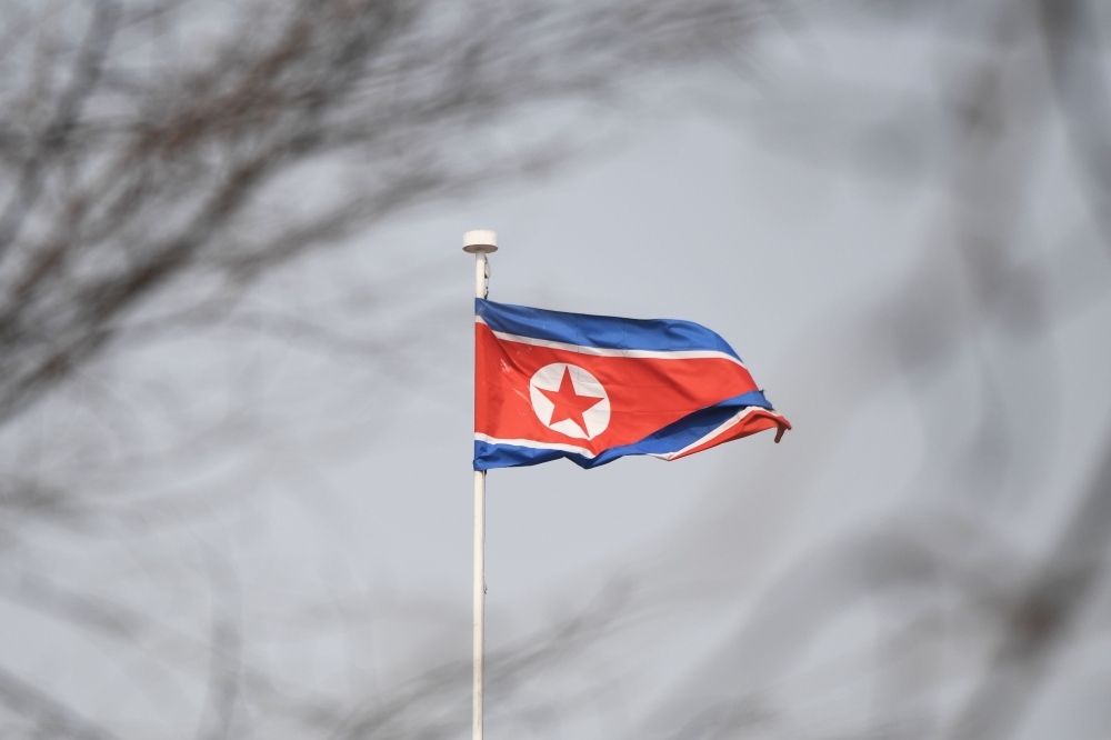 The North Korean flag flies above the North Korean embassy in Beijing on March 9, 2018. US President Donald Trump agreed to a historic first meeting with North Korean leader Kim Jong Un in a stunning development in America's high-stakes nuclear standoff w