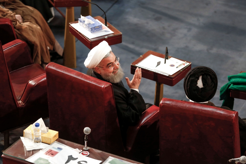 Iran's President Hassan Rouhani (C) attending a session of Iran's Assembly of Experts in the capital Tehran on March 13, 2018. / AFP / ATTA KENARE
