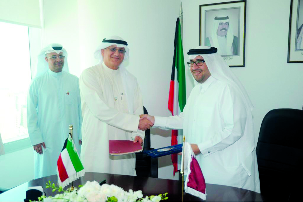 Hassan Al Ibrahim, Acting Chairman of Qatar Tourism Authority (QTA) and Jassim Al Habib, Tourism Sector Undersecretary of Kuwait, exchanging the signed documents at the Tourism Sector headquarters in Kuwait City, yesterday. 
