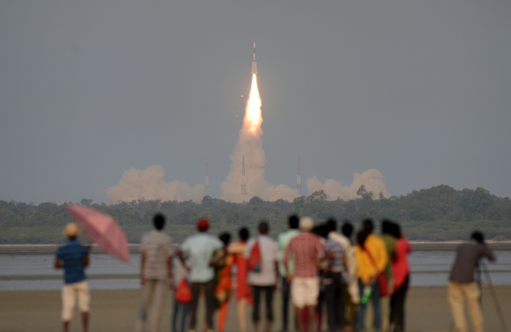 (FILES) In this file photo taken on March 29, 2018, shows Indian onlookers watching as the Indian Space Research Organisation's (ISRO) GSAT-6A communications satellite launches on the Geosynchronous Satellite Launch Vehicle (GSLV-F08) from Sriharikota in 