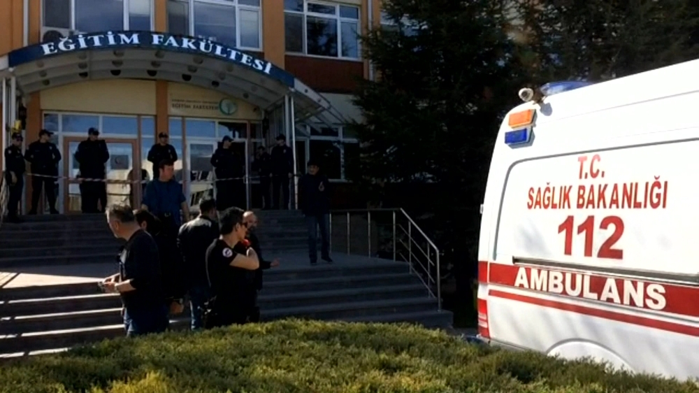 Turkish police officers and an ambulance stand at the entrance of Osmangazi University, on April 5, 2018, after a university employee killed four fellow staff members in a shooting, in the western Turkish city of Eskisehir. (AFP / DOGAN NEWS AGENCY / DHA)