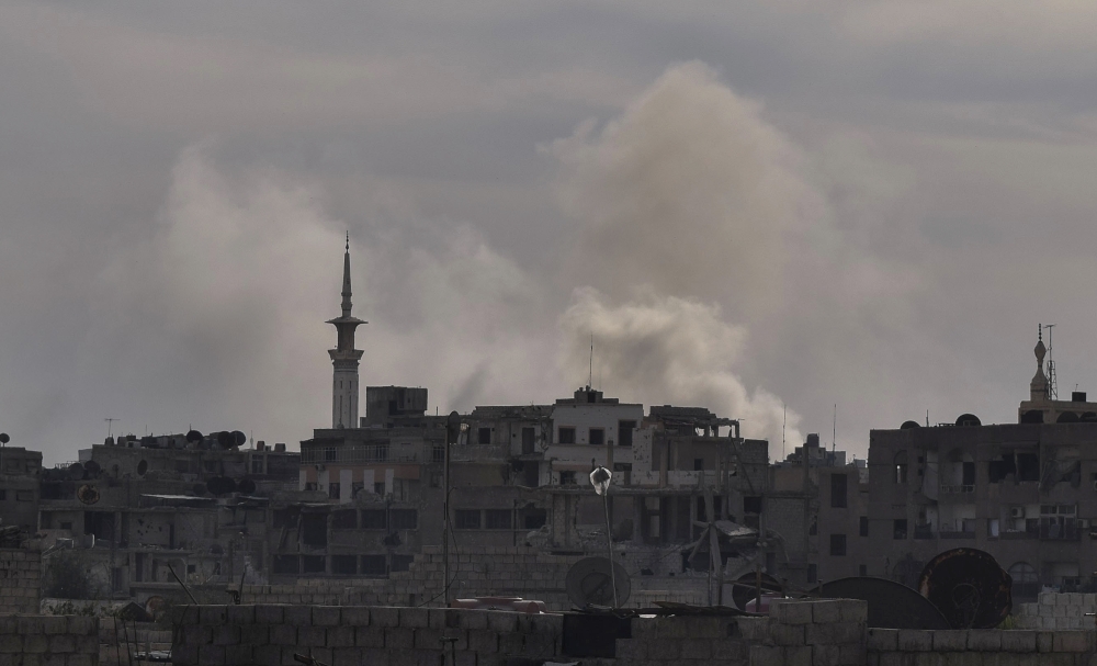 Smoke rises after Assad Regime carried out an airstrike at Duma town of Eastern Ghouta in Damascus, Syria on April 07, 2018. Mouneb Taim - Anadolu
