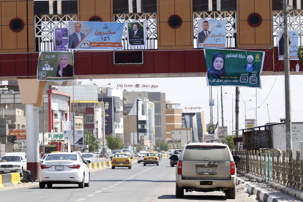 An image of the city of Basra shows campaign billboards for Iraqi candidates in the upcoming parliamentary elections, April 14, 2018. / AFP / HAIDAR MOHAMMED ALI 