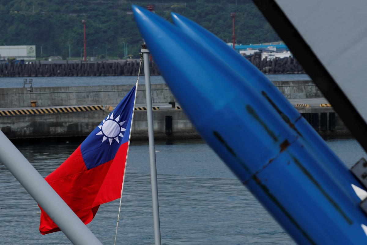 A Taiwanese flag is seen behind standard Type II missiles on Kee Lung (DDG-1801) destroyer during a drill near Yilan naval base, Taiwan. Reuters/Tyrone Siu
