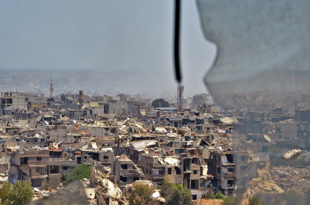 A picture taken during a government guided tour near Damascus' southern al-Qadam neighbourhood shows destruction in Yarmuk, a Palestinian refugee camp on the edge of the capital, as the regime continue their offensive to oust the Islamic State (IS) group 