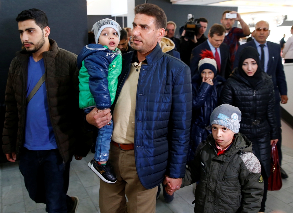 Unidentified people from Douma, Syria, arrive at a news conference in the Hague, Netherlands, April 26, 2018. Reuters/Michael Kooren