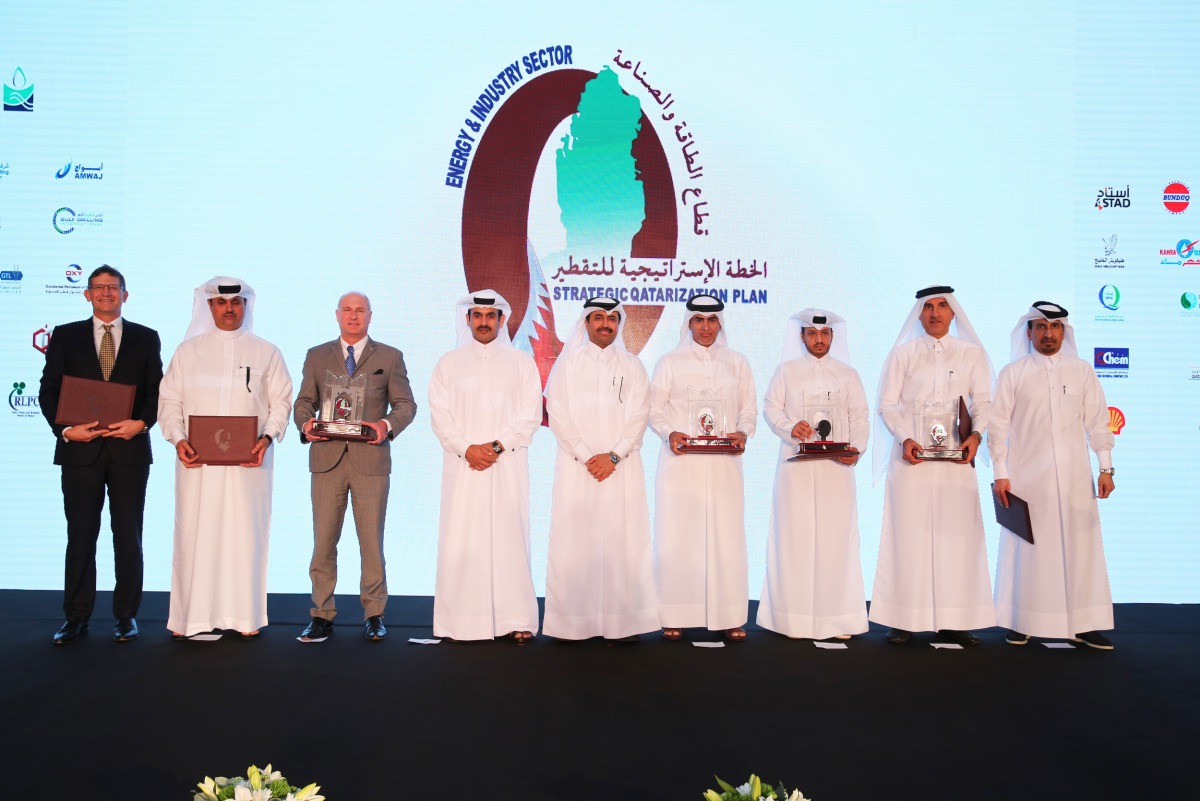 Minister of Energy and Industry, H E Dr Mohammed bin Saleh Al Sada (centre), and  Qatar Petroleum President and CEO, Eng. Saad bin Sherida Al Kaabi (fourth left), with the winners of the 10th Qatarisation awards for the companies in the sector that have s