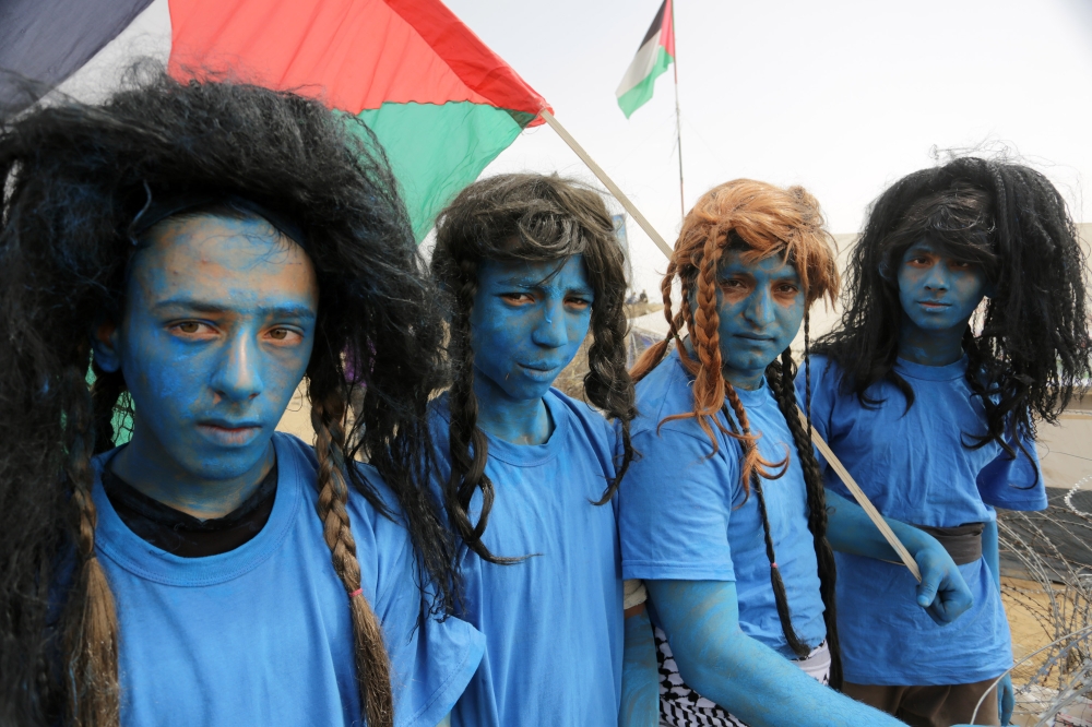 A group of Palestinian, dressed as Na'vi race in the movie Avatar, stage a demonstration to protest Israeli violations against Palestinians, within the 