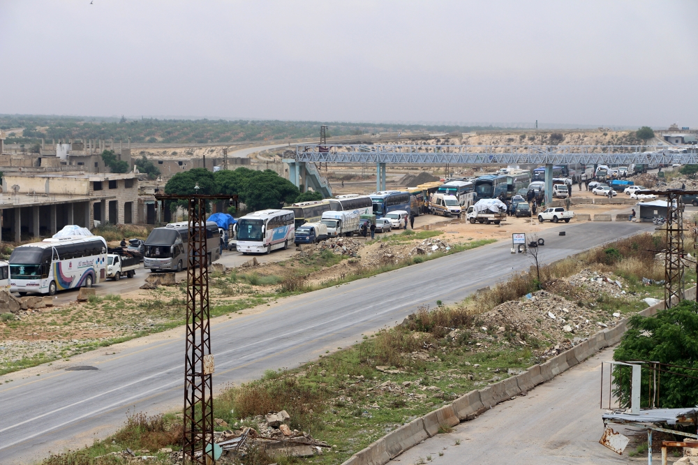 The fifth convoy carrying civilians depart from Homs, Syria due to Assad regime's intense assaults and blockage as part of the compulsory evacuation to reach Idlib and western Aleppo on May 13, 2018.Mohammad Alammory - Anadolu 
