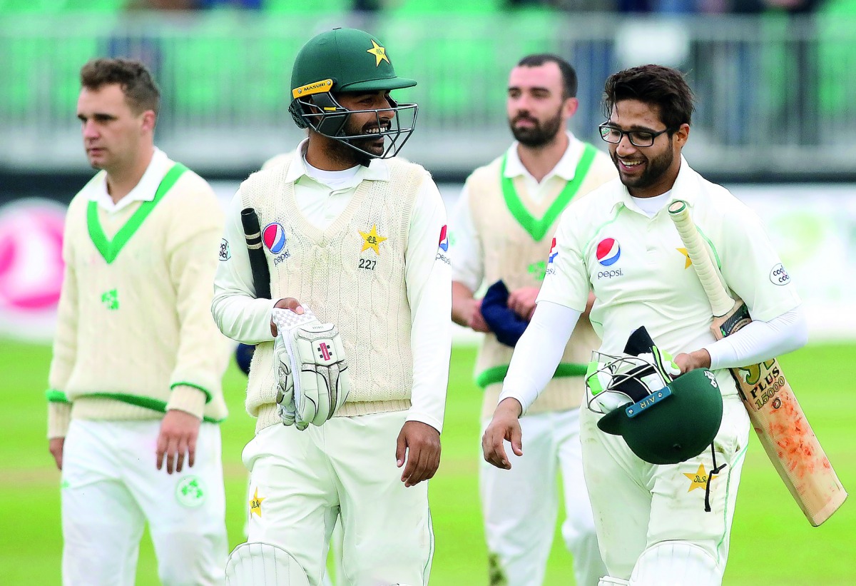 Pakistan's Imam-ul-Haq (R) and Khan Shadab celebrate after beating Ireland on the final day of Ireland's inaugural test match against Pakistan at Malahide cricket club, in Dublin on May 15, 2018. AFP / Paul Faith