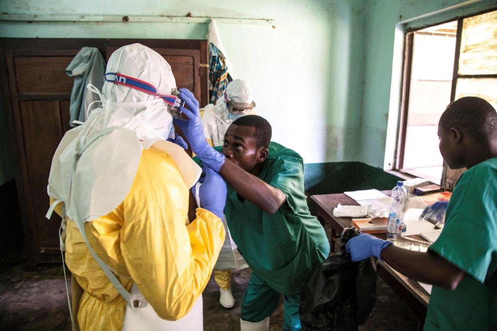 Health workers wear protective equipment as they prepare to attend to suspected Ebola patients at Bikoro Hospital - the epicenter of the latest Ebola outbreak in the Democratic Republic of Congo - on May 12, 2018, which has sealed off a ward to diagnose s