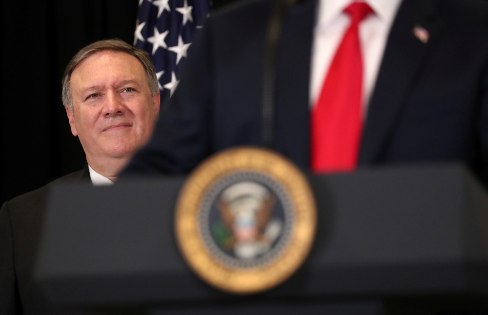 US President Donald Trump is watched by Secretary of State Mike Pompeo as they take part in the swearing-in ceremony for the Central Intelligence Agency's first female director, Gina Haspel, at CIA Headquarters in Langley, Virginia, May 21, 2018. Reuters/