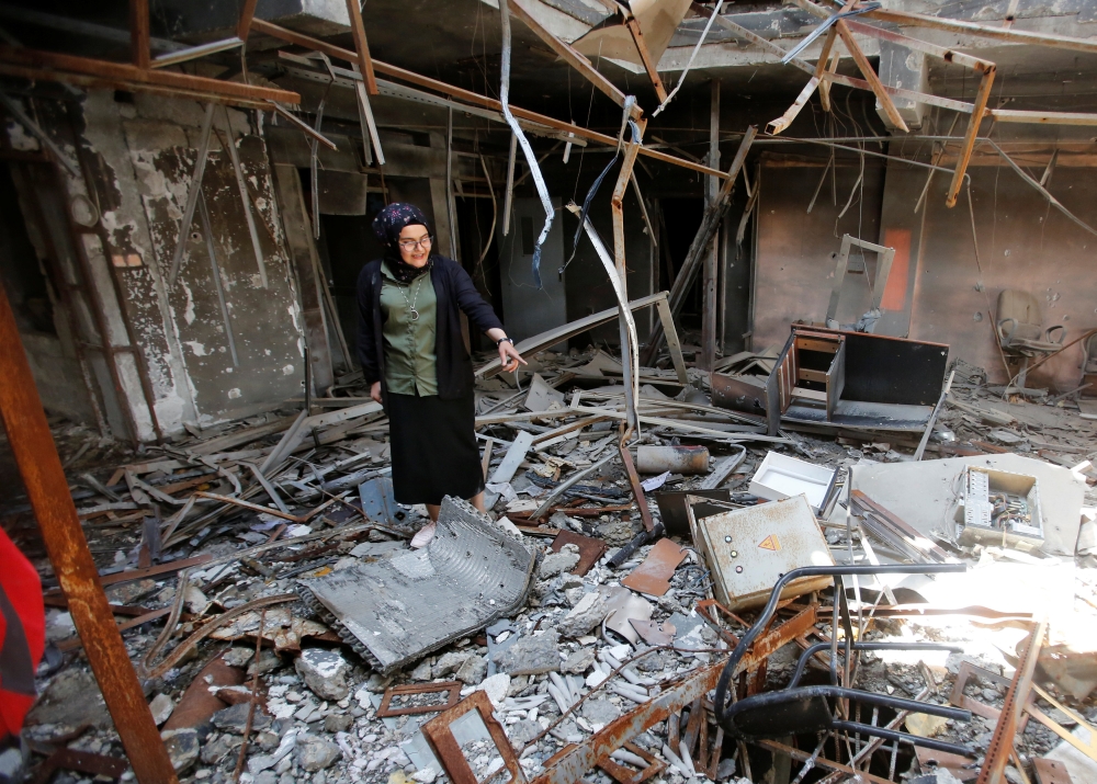Raghad Hammoudi, who is a member of a group of students campaigning to help rebuild the Central Library of Mosul University, speaks with Reuters, in Mosul, Iraq May 14, 2018. Picture taken May 14, 2018. REUTERS/Khalid Al-Mousily