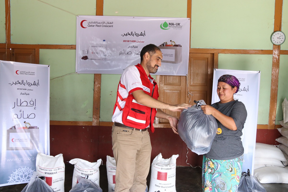 A QRCS official handing over the parcel.