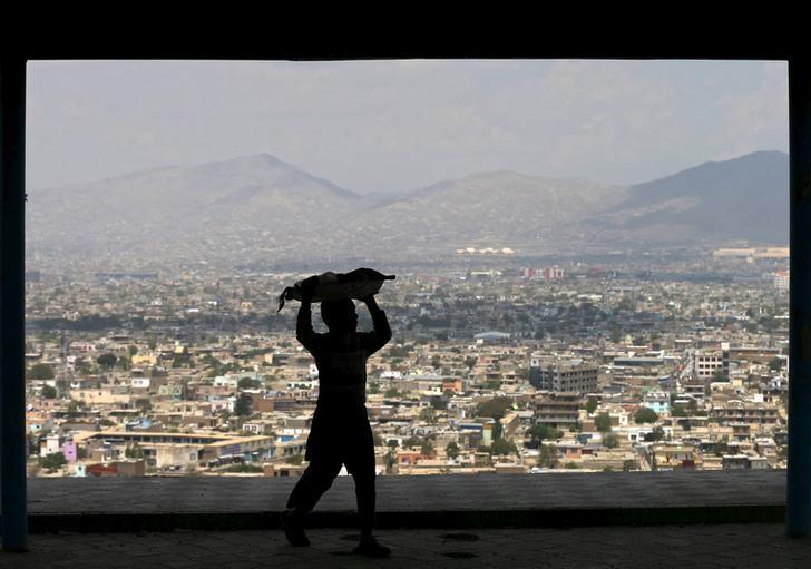 FILE PHOTO of a boy carrying bread on his head to sell on a hilltop overlooking Kabul April 20, 2015. Reuters 