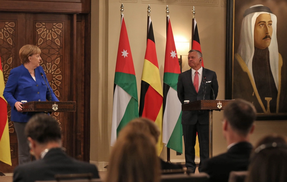 German Chancellor Angela Merkel (L) speaks during a press conference with Jordan's King Abdullah II at the Royal Palace in the Jordanian capital Amman on June 21, 2018. AFP / Khalil Mazraawi