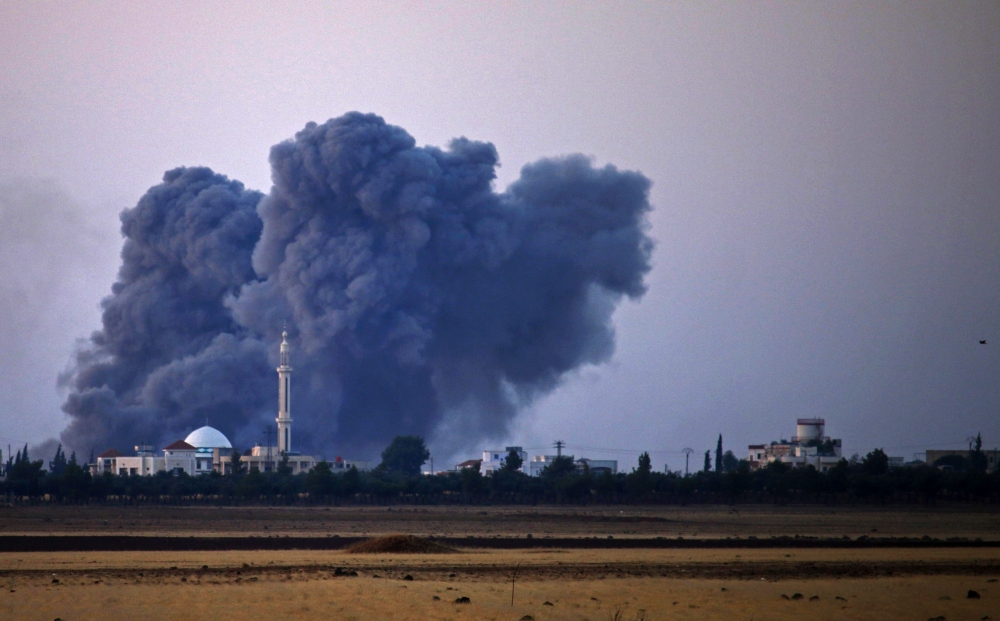 Smoke rises above rebel-held areas of the city of Saida, some 10 kilometers east of Daraa, during reported airstrikes by Syrian regime forces on July 4, 2018. AFP / Mohamad Abazeed