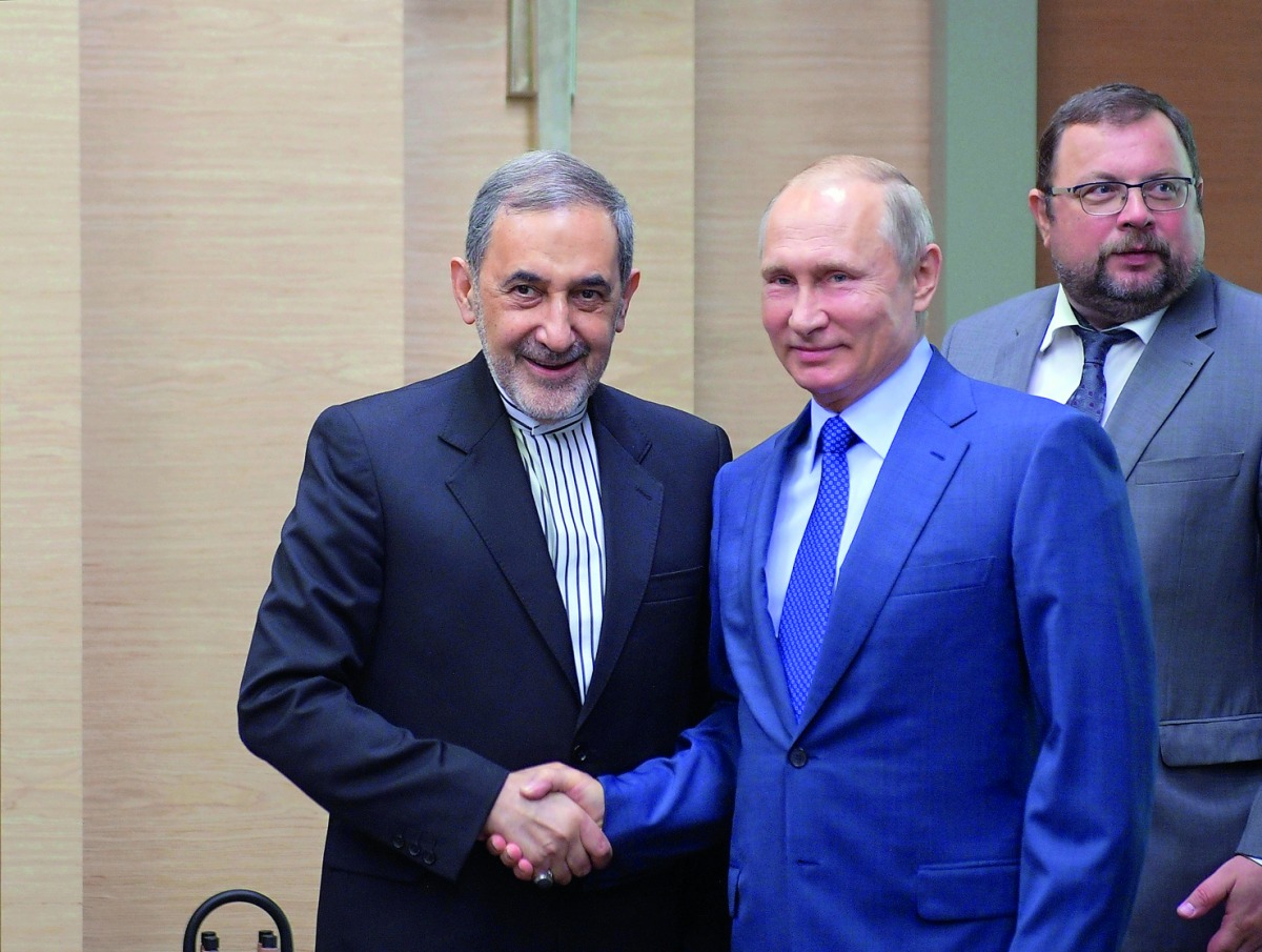 Russian President Vladimir Putin shakes hands with Ali Akbar Velayati, a top advisor to Iran's Supreme Leader Ayatollah Ali Khamenei, during their meeting at the Novo-Ogaryovo state residence outside Moscow, Russia July 12, 2018. Sputnik/Alexei Druzhinin/