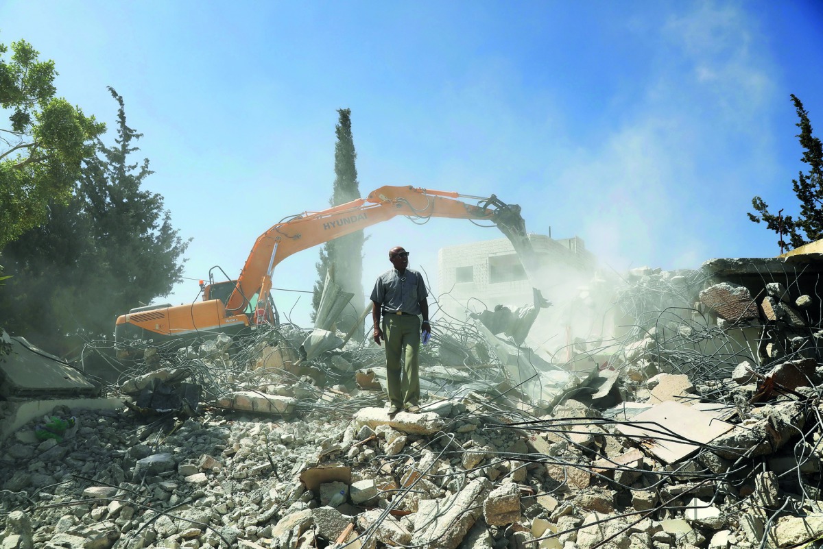 Palestinian Jihad Shawamrah stands on the ruins of his house that he demolished to not face the prospect of Israeli settlers moving in after he lost a land ownership case in Israeli courts, in the East Jerusalem neighbourhood of Beit Hanina, July 19, 2018