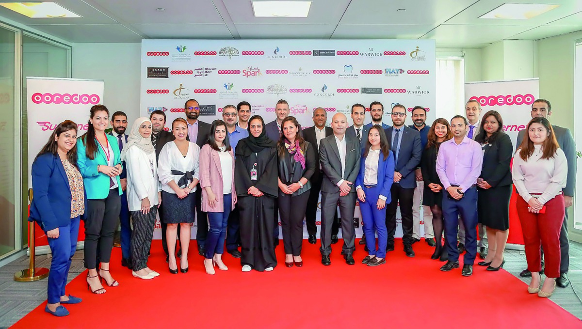 Ooredoo’s Nojoom partners with officials during the event at Ooredoo’s Tower in West Bay. 
