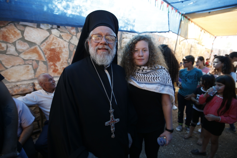 Palestinian activist and campaigner Ahed Tamimi (R) poses for a picture with Archimandrite Abdullah Yulio, parish priest of the Melkite Greek Catholic church in Ramallah, in the West Bank village of Nabi Saleh on July 29, 2018, upon her release from priso