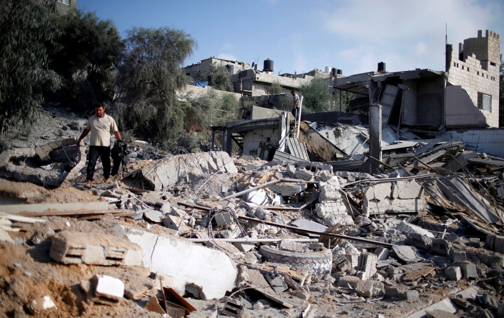 A Palestinian man inspects a site that was hit in an Israeli air strike, in Al-Mughraqa on the outskirts of Gaza City August 9, 2018. (REUTERS/Mohammed Salem)