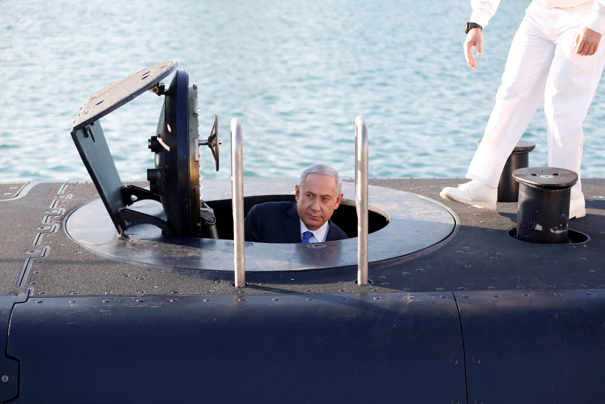 Israeli Prime Minister Benjamin Netanyahu climbs out after a visit inside the Rahav the fifth submarine in the fleet after it arrived in the Haifa port January 12, 2016. Reuters/Baz Ratner
