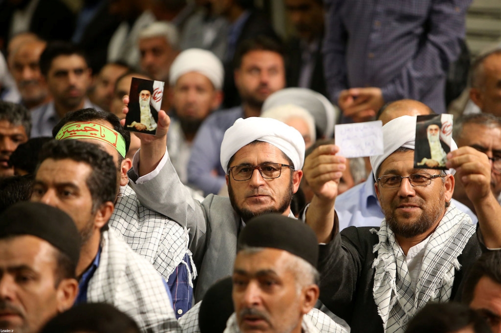 People hold a picture of Iran's Supreme Leader Ayatollah Ali Khamenei, at the Hussayniyeh of Imam Khomeini in Tehran, Iran, August 13, 2018. Official Khamenei website/Handout via Reuters