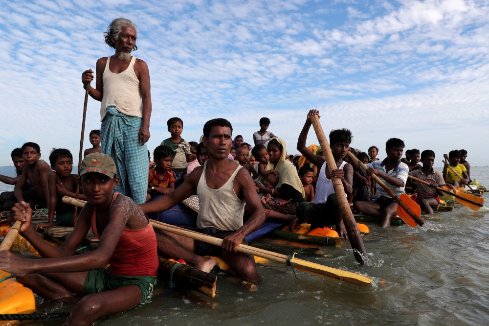 FILE PHOTO: Rohingya refugees cross the Naf River with an improvised raft to reach to Bangladesh in Teknaf, Bangladesh, November 12, 2017. REUTERS/Mohammad Ponir Hossain
