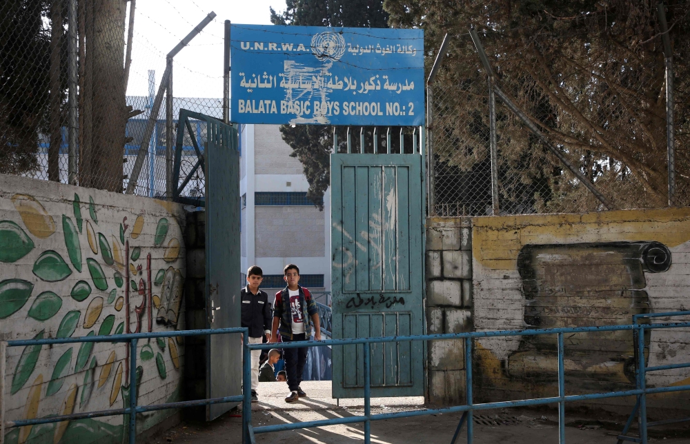 Children return to school at an establishment run by United Nations agency for Palestinian refugees (UNRWA) in Balata refugee camp, east of Nablus in the occupied West Bank on August 29, 2018, on the first day of classes after the summer holidays. AFP / J