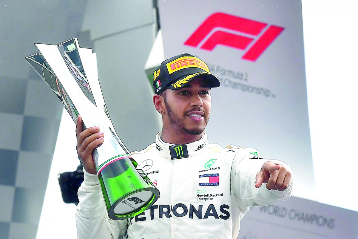 Mercedes' British driver Lewis Hamilton holds his trophy on the podium after winning the Italian Formula One Grand Prix at the Autodromo Nazionale circuit in Monza on September 2, 2018. AFP / Andrej Isakovic
