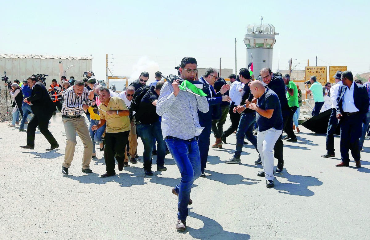 Israeli forces disperse Palestinian journalists during a protest, which was organized by Palestinian Journalists Syndicate, to show solidarity with Palestinian journalist Ali Dar Ali, who remains incarcerated in Israel’s Ofir prison, demanding his release