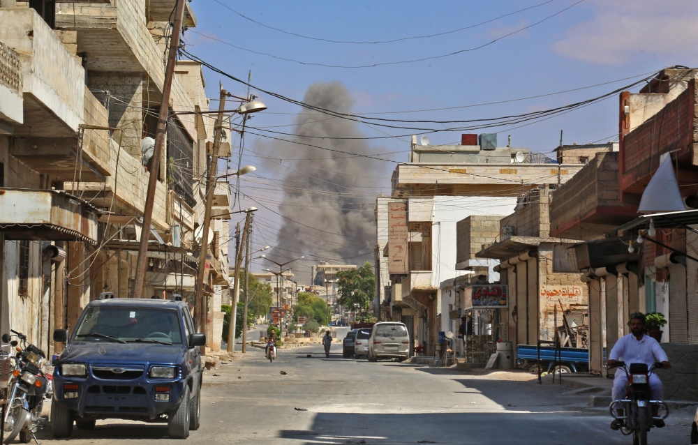 This picture taken in Kafr Ain on September 7, 2018, shows smoke rising as government forces target the city of Khan Shaykhun in the southern countryside of Idlib province. / AFP / Anas AL-DYAB