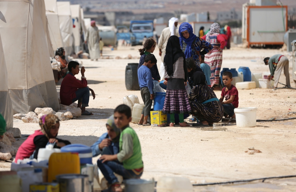 People who fled Syria's Idlib province are pictured at a camp in Kafr Lusin near the border with Turkey in the northern part of the province on September 9, 2018. AFP / Aref Tammawi

