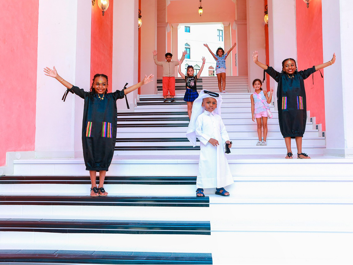 Children play on the Music steps at Qanat Quartier. 
