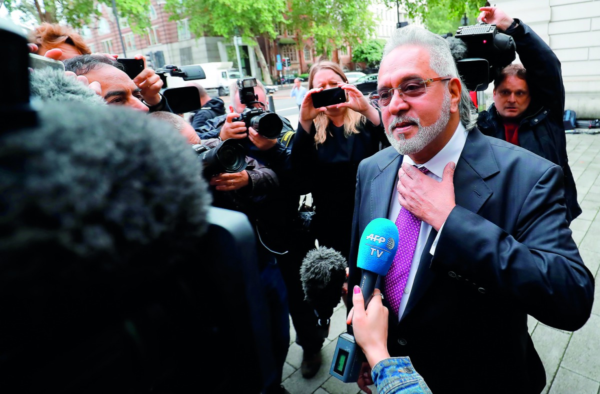 Vijay Mallya speaks to members of the media as he arrives to appear at Westminster Magistrates Court in central London on September 12, 2018, to attend the closing arguements in his extradition hearing.  AFP / Tolga Akmen
 