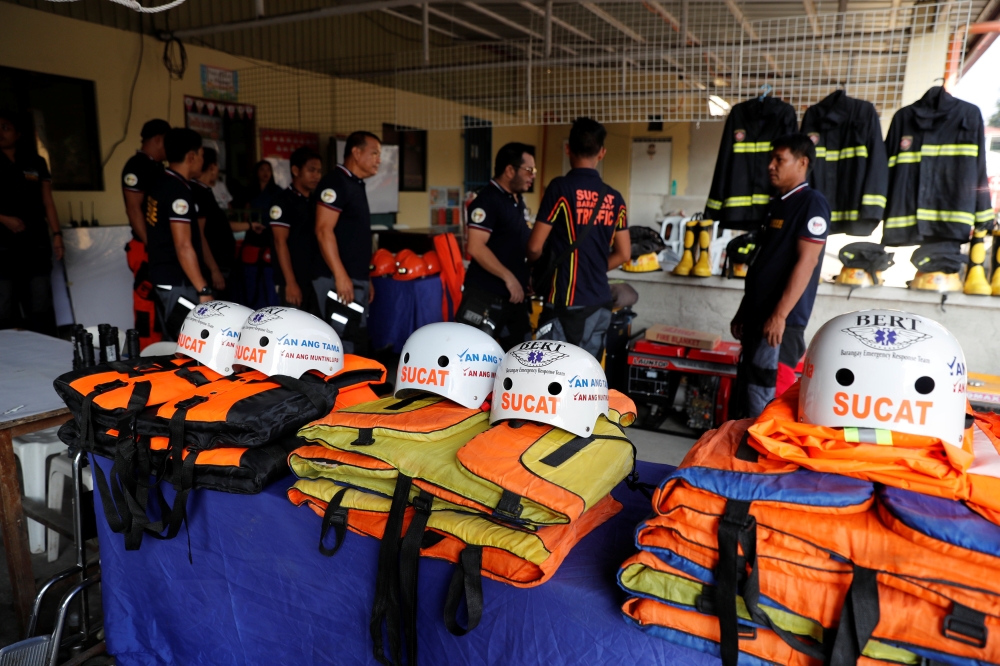 Rescuers ready their gear before Super Typhoon Mangkhut hits the main island of Luzon, in Muntinlupa, Metro Manila, in Philippines, September 13, 2018. Reuters/Erik De Castro

