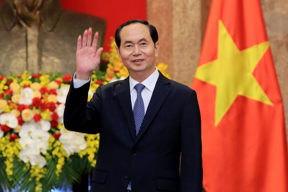 In this file photo taken March 23, 2018, Vietnamese President Tran Dai Quang greets journalists as he waits for the arrival of Russian Foreign Minister Sergei Lavrov (not pictured) at the Presidential Palace. / AFP / POOL / MINH HOANG 