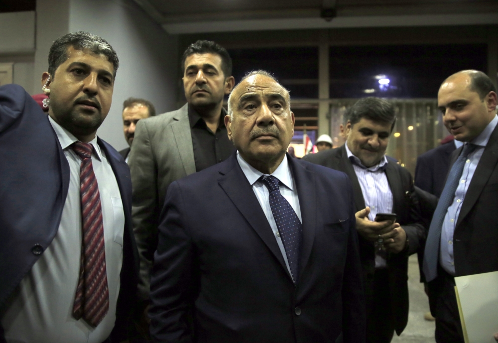 Independent Shia candidate Adil Abdul-Mahdi (C) is seen after newly elected president Barham Salih (not seen) has given the task to form the government to Adil Abdul-Mahdi at the the Iraqi Parliament building in Baghdad, Iraq on October 2, 2018. Murtadha