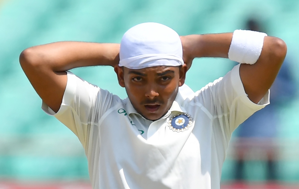 Indian cricketer Prithvi Shaw ties a bandana on his head during the first day of the first Test cricket match between India and West Indies at the Saurashtra Cricket Association stadium in Rajkot on October 4, 2018. GETTYOUT / AFP / INDRANIL MUKHERJEE