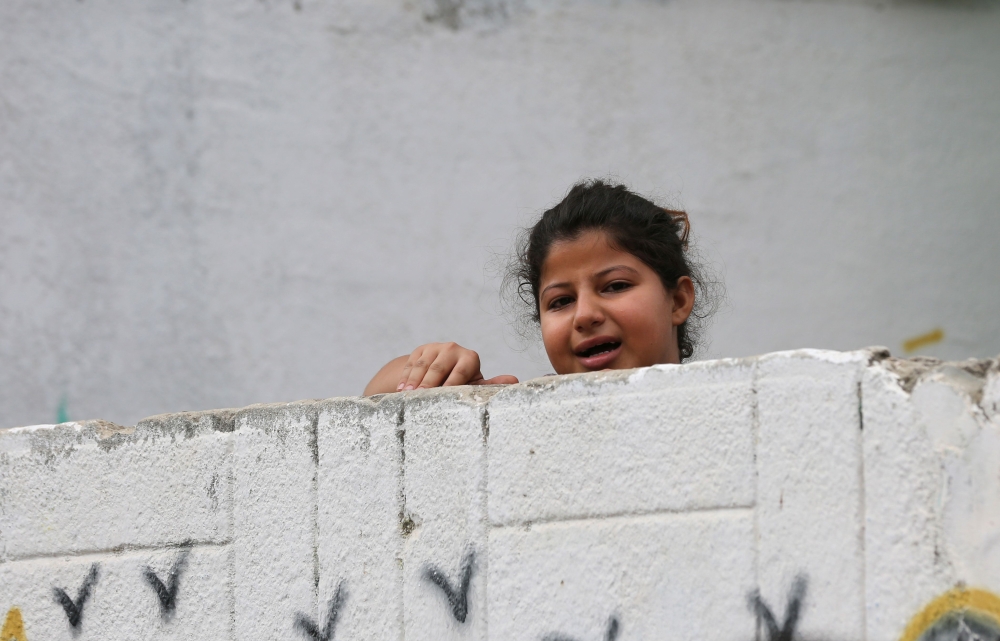 A young relative of a 25 year old Palestinian killed watches his funeral procession in the northern Gaza Strip on October 17, 2018.  AFP / Mahmud Hams